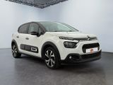 a white citrole is parked in a large room