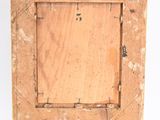 an old wooden picture frame with a hole in the middle of it
