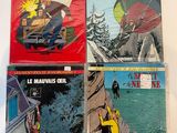 four comics are on a white surface with a red background