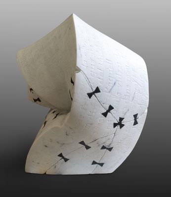 a white vase with black and white designs on it