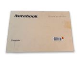 a close up of a notebook on a white surface with a red dot