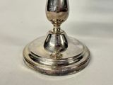 a silver cup sitting on top of a silver plate