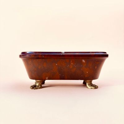 a brown bath tub with a brown lid on a white surface