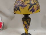 yellow and purple lamp with a black base and a black base with a yellow and purple lamp shade