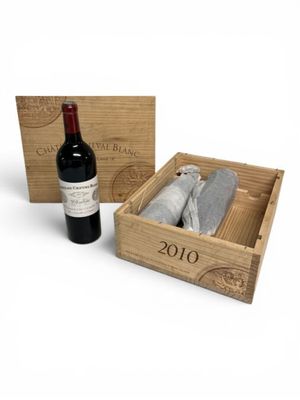 a bottle of wine in a wooden box next to a bottle of wine
