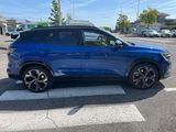 a blue suv parked on the side of the road in a parking lot