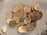 a pile of coins sitting on a table next to a pile of coins