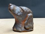 a statue of a dog that is sitting on a table