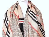 beige scarf with black, red, and white stripes and a black tie