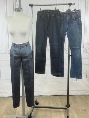 a mannequin and jeans on a stand in a room