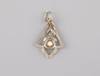 a close up of a silver pendant on a white surface