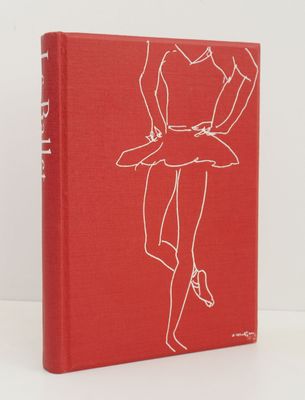 a red book with a drawing of a woman in a skirt