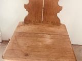 a wooden chair with a heart shaped seat on it