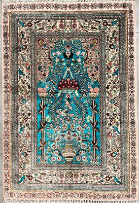a blue rug with a bird and flowers on it