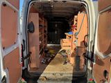 a white van with a door open in a yard