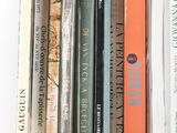 a lot of books that are stacked on a shelf