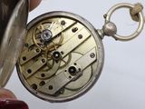 a close up of a pocket watch being held by a person