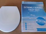 a box with a toilet seat and a book on it