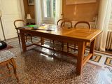 a wooden table and chairs in the middle of a room