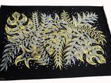 a close up of a black cloth with yellow and blue flowers on it