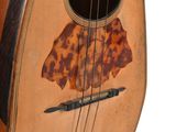 a guitar that is sitting on a white surface