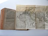 an open book with a map on it sitting on a table