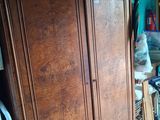 an image of a bedroom with a large wooden armoire