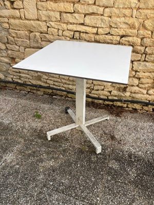an image of a white square table on a metal stand