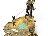 bronze figurine of a boy with a dog and a dragonfly