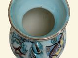 a blue and white vase with a fish design on it