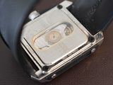 a close up of a watch on a leather surface