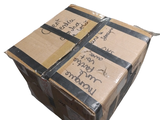 a cardboard box with writing on it sitting on a white surface