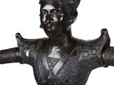 bronze statue of a man with a hat on his head and arms outstretched