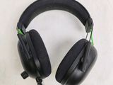 a pair of black headphones on a white surface
