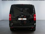 the back of a black van is parked in a garage