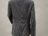 a mannequin wearing a suit and tie on a mannequin stand
