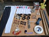 a table with many items on it including glasses, a pair of scissors, a pair of scissors, a pair of glasses, a pair of scissors,