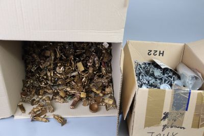 two boxes with a bunch of metal items inside of them
