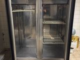 a double glass door refrigerator in a kitchen with tile flooring