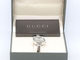 a box with a watch inside of it on a white surface