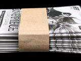 newspapers stacked on top of each other on a black background