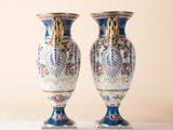 pair of blue and white vases sitting on top of a white table