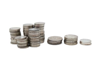 a pile of coins sitting next to each other on top of a white surface