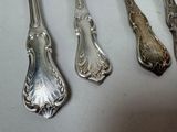 five spoons that are sitting on a table
