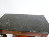 une petite table avec un plateau en marbre noir