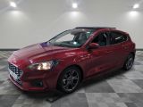 a red ford focus parked on a checkered tile floor