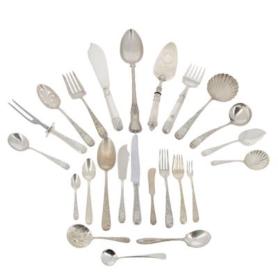 a lot of silver spoons and forks arranged in the shape of a circle