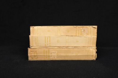 three books stacked on top of each other on a black surface
