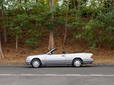 a silver convertible car parked on the side of the road
