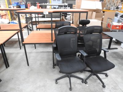 two office chairs that are sitting in the middle of a room